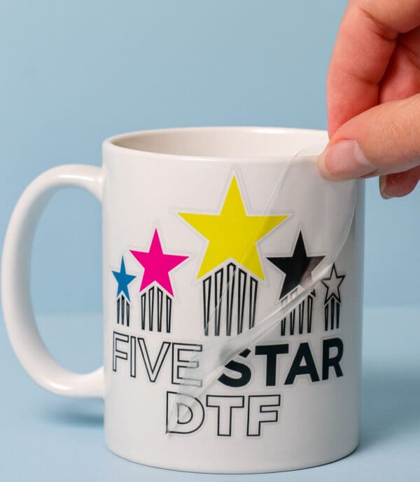 UV DTF sticker transfer applied to a coffee mug showing glossy logo print