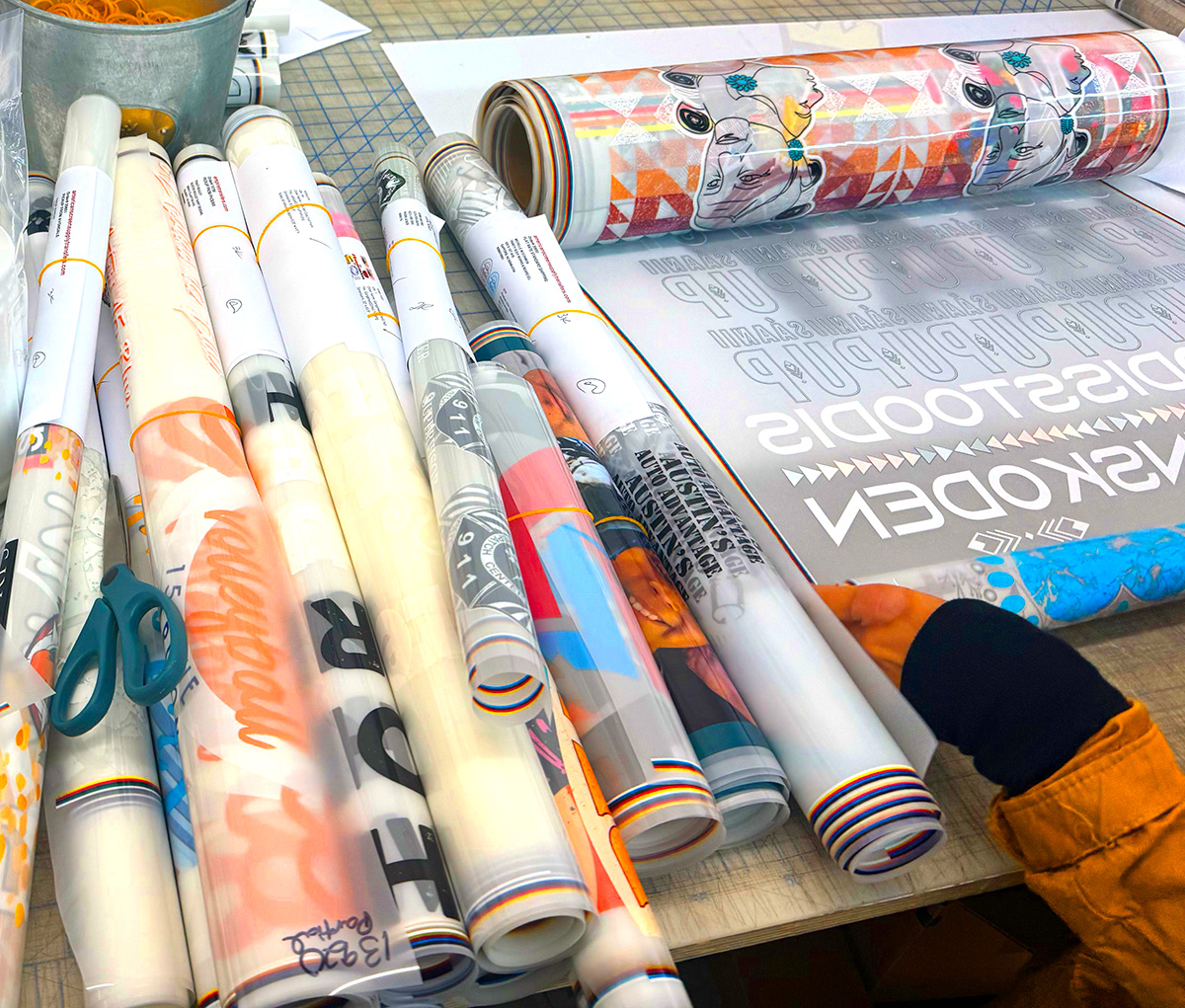 premium-dtf-transfer-film-rolls-for-shirts-and-apparel-printing-arizona Premium DTF transfer film rolls with colorful printed designs for custom shirt and apparel printing in Arizona
